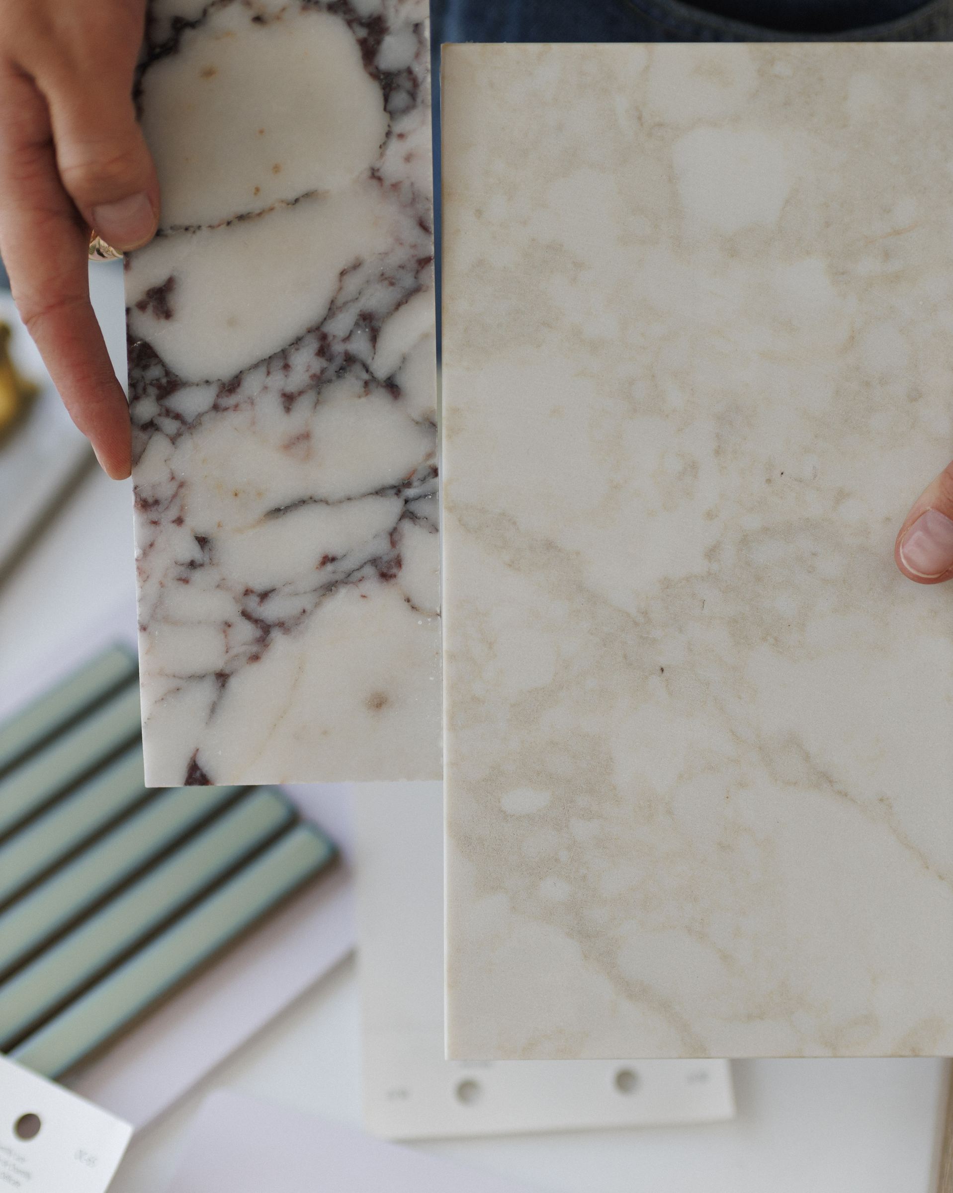 Two marble samples compared side by side, with green ribbed tile below